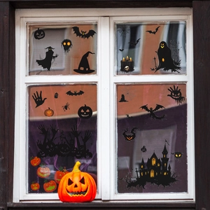 Halloween window decals featuring bats, castle, and pumpkins on a white glass window