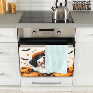 Halloween magnetic dishwasher sticker with cute cartoon dog, pumpkins, and bats on a white door