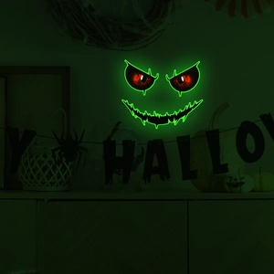 Glow-in-the-dark Halloween wall sticker featuring spooky red eyes and green jagged mouth