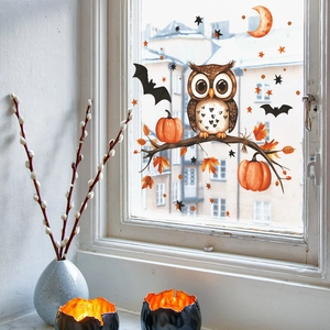 Halloween window clings featuring owls, pumpkins, and bats on a glass window pane