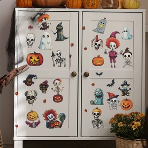 Halloween window decals set featuring pumpkins and skeletons on white cabinet surface