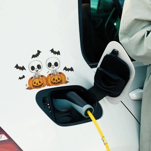 Halloween car sticker with cute skeletons inside a pumpkin and black bats on white car body