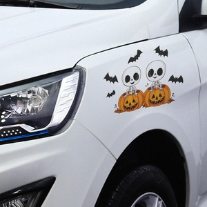 Halloween car sticker featuring cartoon skeletons in pumpkins and flying bats on a white car