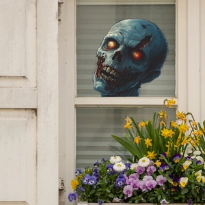 Sticker de fenêtre Halloween avec zombie bleu et yeux rouges brillants sur verre