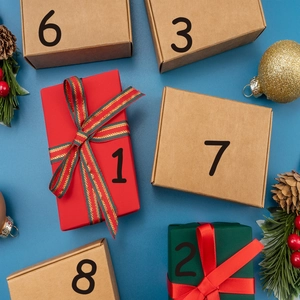 Christmas advent calendar gift boxes set with numbered tags and festive pinecone decor