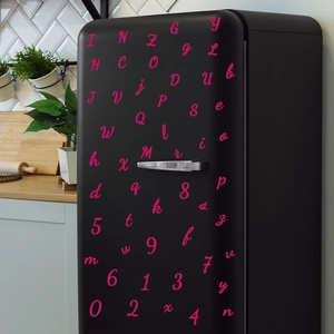 Creative pink script alphabet and number stickers on a vintage black refrigerator surface