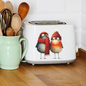 White 2-slice toaster with cute winter birds illustration in a bright kitchen