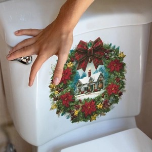 Christmas wreath wall sticker featuring snow house and red bow on white toilet tank