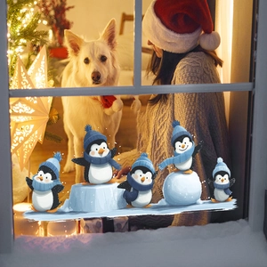 Christmas window stickers featuring cute cartoon penguins on ice for holiday home decoration