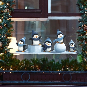 Cartoon skating penguins Christmas window stickers with festive holiday decorations