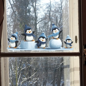 Cartoon skating penguins Christmas window stickers set on glass with winter forest view