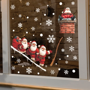 Christmas Santa Claus window stickers with snowflakes on glass in a cozy festive setting