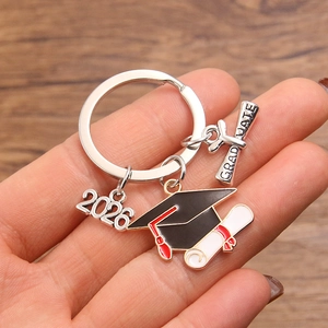 2026 graduation keychain featuring black doctoral cap and graduate scroll charms