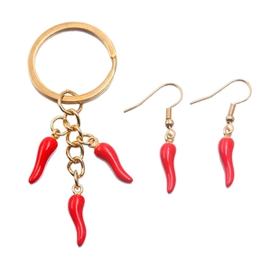 Golden keychain and earrings set with bright red enamel chili pepper pendants