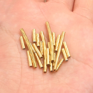 Golden spiral textured stainless steel tube beads for DIY jewelry making on hand