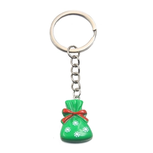 Christmas keychain with green lucky bag pendant, red bow and snowflake on silver chain