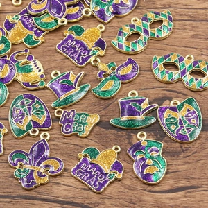 Close-up of Mardi Gras enamel charms in gold, purple and green with glitter finish
