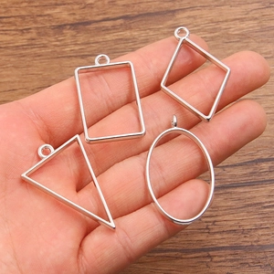 Set of silver geometric alloy charms in rectangle, diamond, triangle and oval shapes