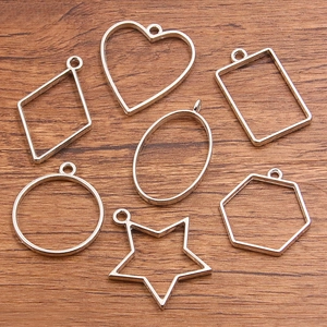 Seven silver DIY alloy open bezels in geometric shapes for resin crafts and pendants