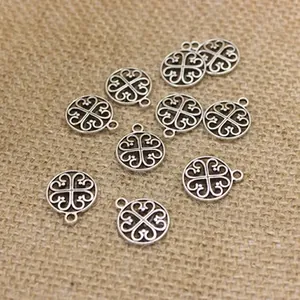Macro detail of 10 pieces antique silver alloy heart-shaped clover charms for jewelry DIY