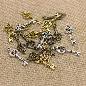 Macro view of vintage hollow round flower charms in assorted bronze and silver finishes