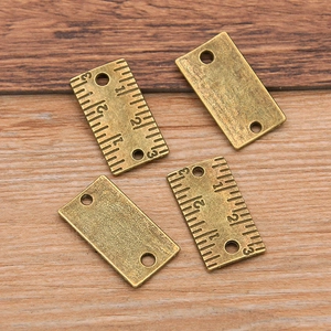 Set of four vintage bronze ruler charms with numeric scales for DIY jewelry making
