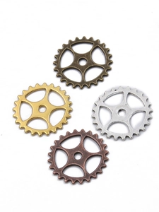 Detailed macro view of four mixed color steampunk alloy gear charms for DIY craft projects