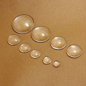 Macro detail of transparent round glass cabochons in various sizes for DIY jewelry making