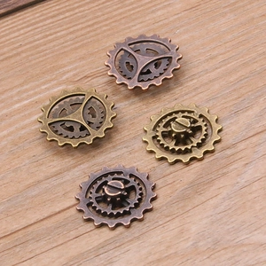 Macro detail of 22mm steampunk alloy gear charms in antique bronze and copper finish