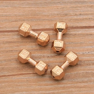 Detail of rose gold dumbbell charm with LIFT and LIVE engraving for DIY jewelry