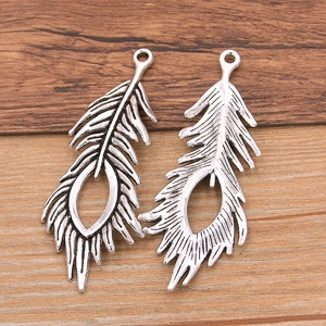 Pair of vintage silver hollow peacock feather alloy pendants for DIY jewelry making