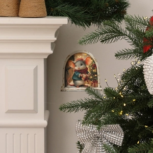 Detail showing a 3D Christmas mouse hole wall sticker with a festive mouse and gift