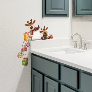 Christmas wall decal featuring cute cartoon reindeer and hanging gift boxes on a white wall