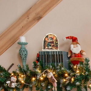 Close-up of a Christmas arched miniature light with a cute mouse and festive tree