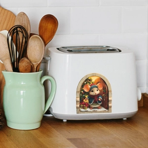 Close-up of a 3D Christmas mouse hole sticker applied on a white toaster side