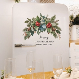 Self-adhesive Christmas wall decals featuring pine cones and berries on a white fridge