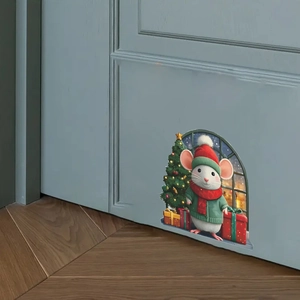 Detail of Christmas mouse wall sticker with Santa hat and tree on a blue door