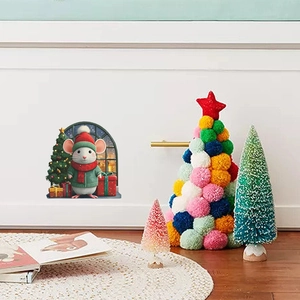 Detailed view of a cute cartoon Christmas mouse wall sticker on a white home wall