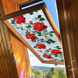 Vibrant rose flower glass window sticker with rainbow laser effect on a wooden attic window