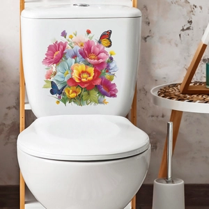 Stickers colorés de fleurs et papillons appliqués sur un réservoir de toilette blanc