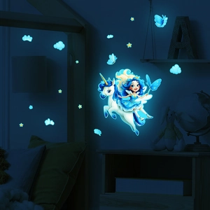 Luminous unicorn and fairy wall stickers glowing bright blue in a dark children's bedroom