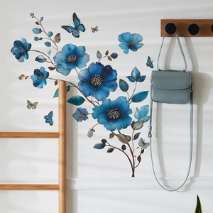 Blue flower and butterfly wall stickers applied to a white wall in a modern home interior