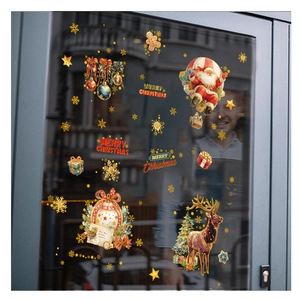 Detail of Christmas window clings featuring Santa, reindeer, and golden snowflakes