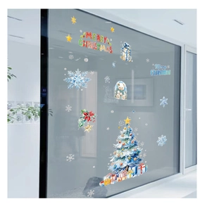 Close-up of static Christmas window decals featuring snowman and tree on glass