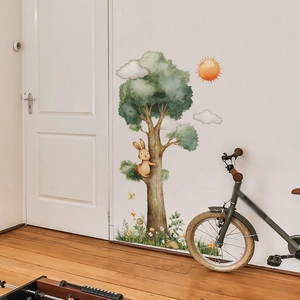 Cartoon wall sticker with a large tree, rabbit, and flowers for children's bedroom decor