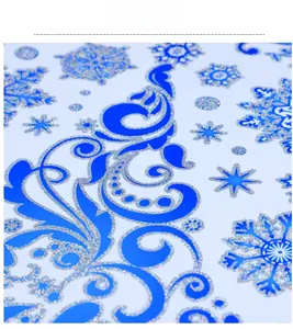 Macro detail of blue and silver glitter snowflake window decals with intricate patterns