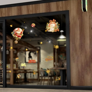 Christmas window decals with Santa Claus in hot air balloon and golden snowflakes