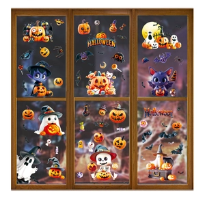 Close-up of Halloween window decals featuring pumpkin, ghost and bat on a glass window