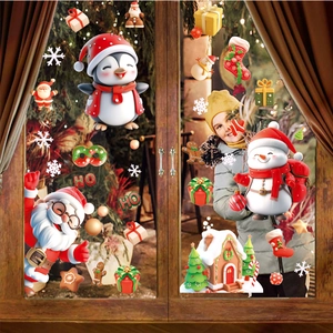 Christmas window clings featuring Santa, snowman, and snowflakes on a cozy wooden window