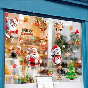 Christmas window decals featuring Santa, reindeer, and snowflakes on a glass window pane